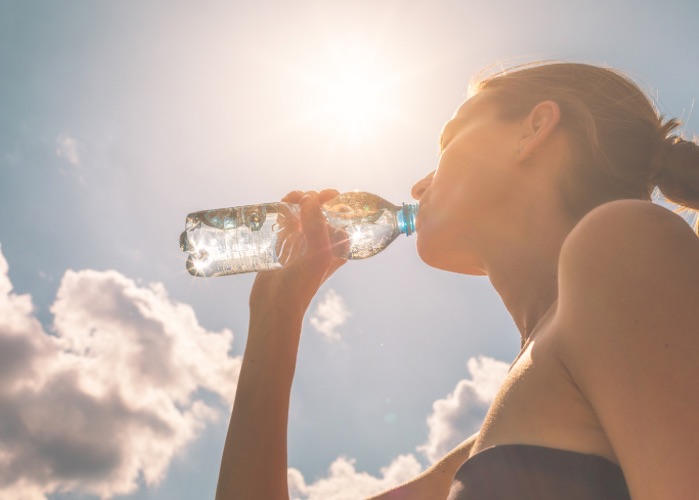 fit woman drinking water from bottle